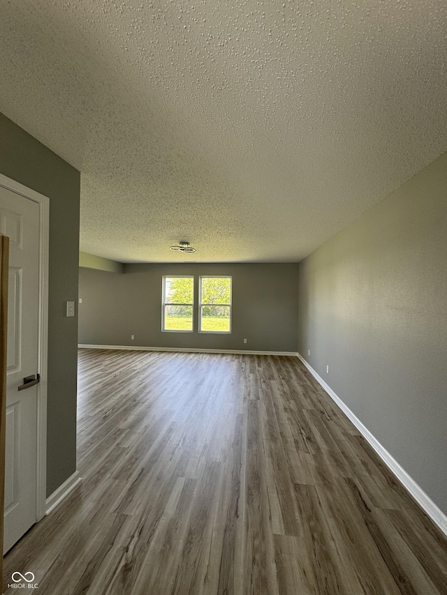 3327 Brandenburg Blvd, Indianapolis, IN 46239 - unfurnished room with a textured ceiling, dark wood finished floors, and baseboards