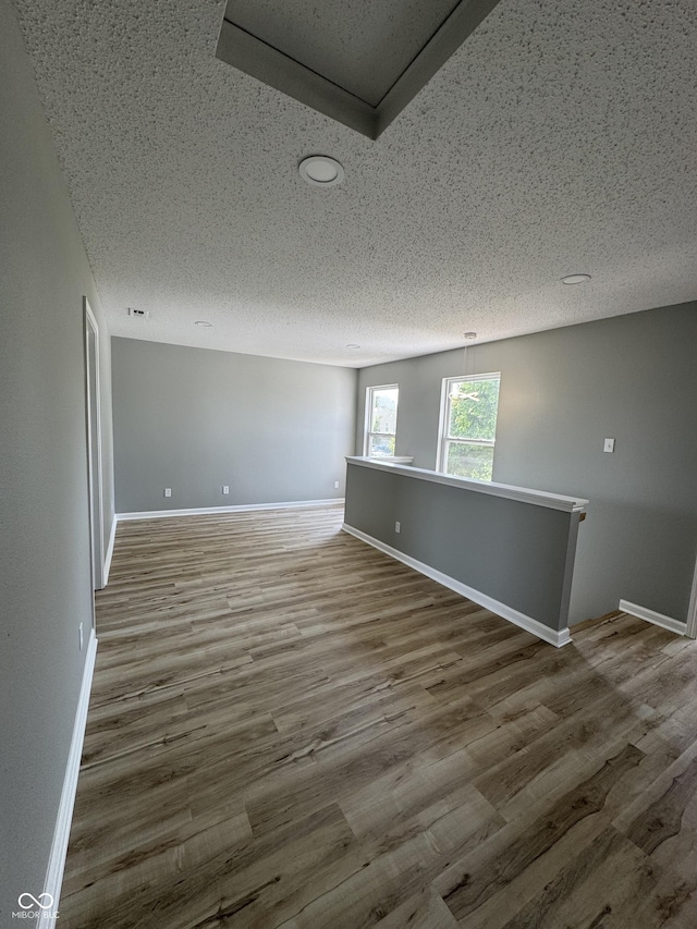 3327 Brandenburg Blvd, Indianapolis, IN 46239 - empty room featuring a textured ceiling, wood finished floors, and baseboards
