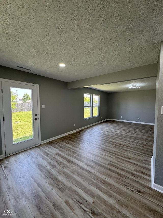 3327 Brandenburg Blvd, Indianapolis, IN 46239 - spare room with wood finished floors, a textured ceiling, and baseboards