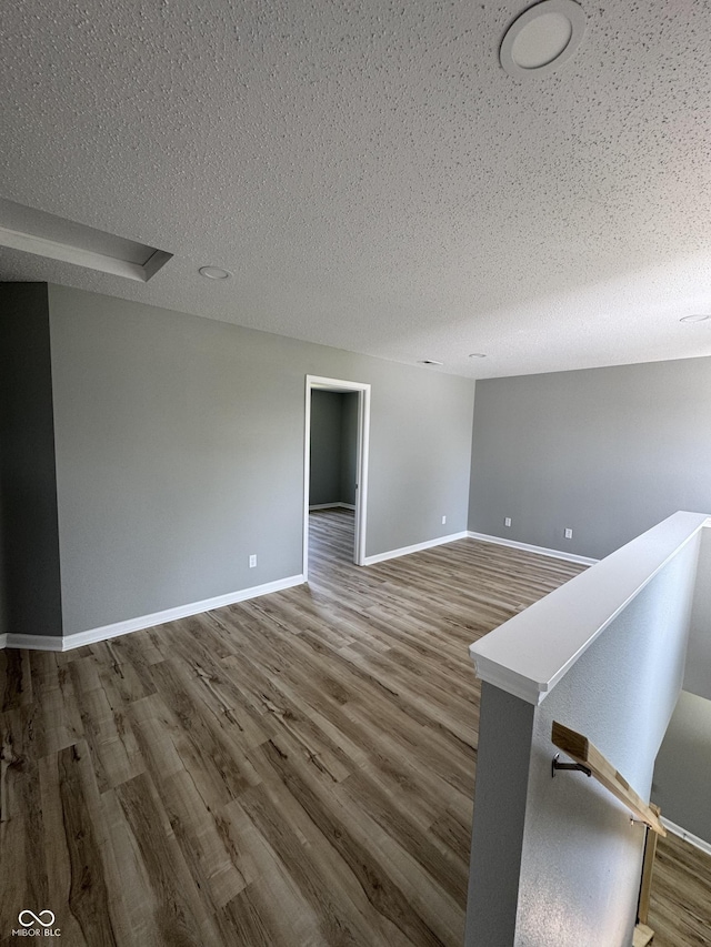 3327 Brandenburg Blvd, Indianapolis, IN 46239 - spare room featuring a textured ceiling, wood finished floors, and baseboards