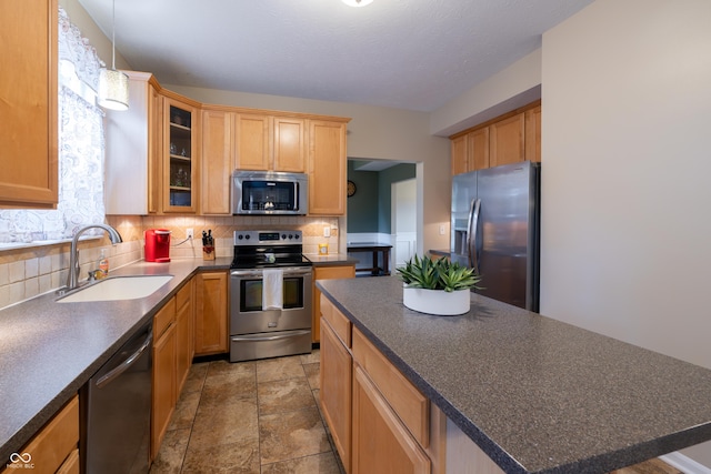 13271 Aquamarine Dr, Carmel, IN 46033 - kitchen featuring appliances with stainless steel finishes, dark countertops, decorative backsplash, and a center island