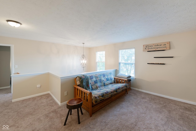 13271 Aquamarine Dr, Carmel, IN 46033 - living area featuring carpet floors, a textured ceiling, a chandelier, and an upstairs landing