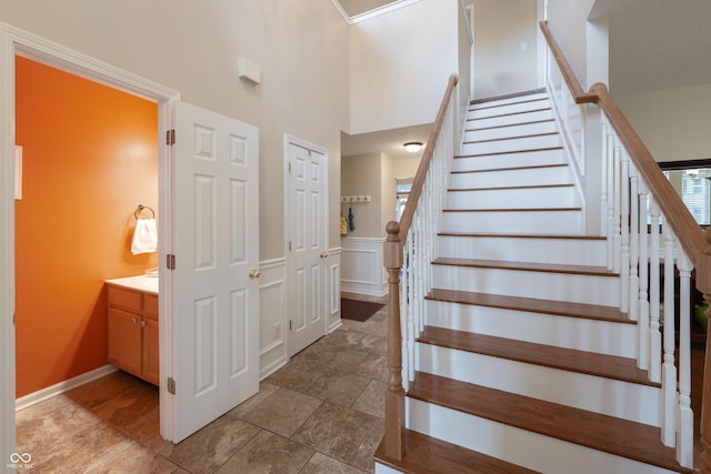 13271 Aquamarine Dr, Carmel, IN 46033 - staircase with a towering ceiling and a wainscoted wall