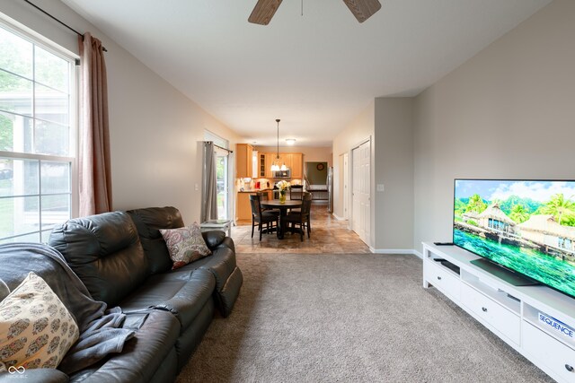 13271 Aquamarine Dr, Carmel, IN 46033 - living area with healthy amount of natural light, ceiling fan, and light colored carpet