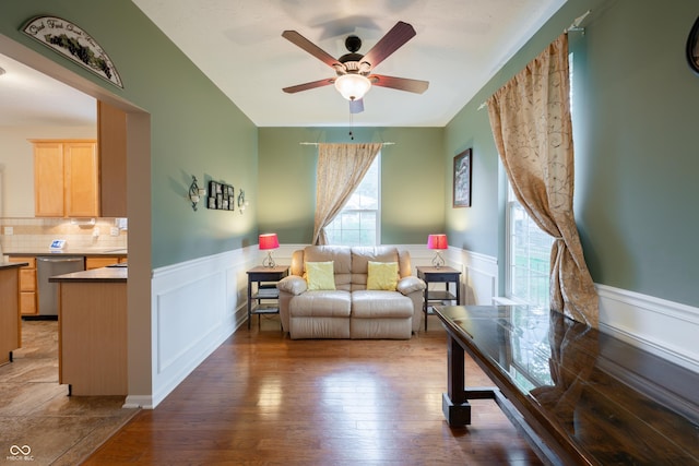 13271 Aquamarine Dr, Carmel, IN 46033 - living area featuring plenty of natural light, wainscoting, ceiling fan, wood finished floors, and a decorative wall