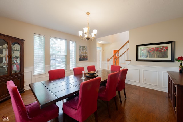 13271 Aquamarine Dr, Carmel, IN 46033 - dining area with a chandelier, stairway, wainscoting, a decorative wall, and wood finished floors