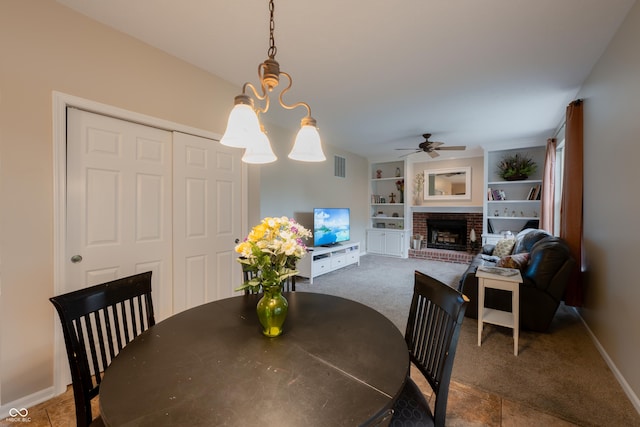 13271 Aquamarine Dr, Carmel, IN 46033 - dining area with a ceiling fan, a fireplace, built in shelves, and carpet