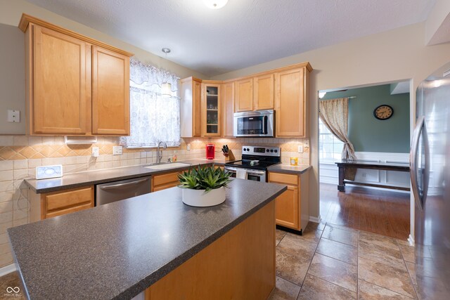 13271 Aquamarine Dr, Carmel, IN 46033 - kitchen with stainless steel appliances, dark countertops, healthy amount of natural light, and light brown cabinets