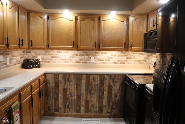 651 N 900 E, Lafayette, IN 47905 - kitchen featuring black appliances, backsplash, and light countertops