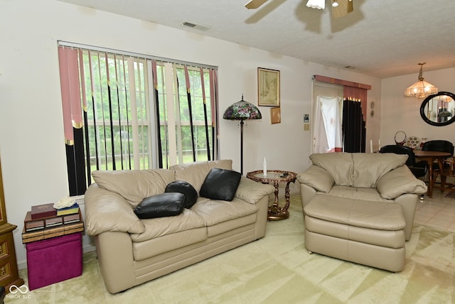 4528 Hunt Master Ct, Indianapolis, IN 46268 - carpeted living room featuring a chandelier, ceiling fan, and a textured ceiling
