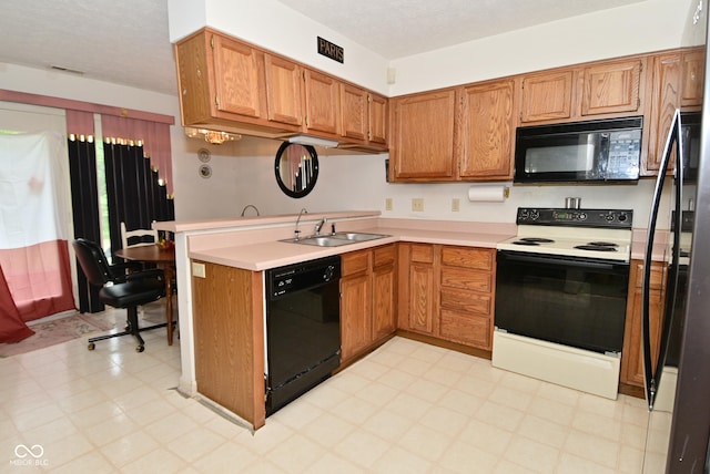 4528 Hunt Master Ct, Indianapolis, IN 46268 - kitchen with black appliances, a sink, light flooring, a peninsula, and brown cabinets