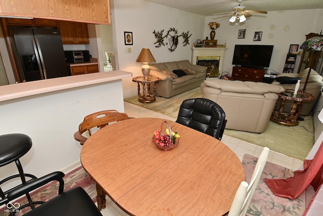 4528 Hunt Master Ct, Indianapolis, IN 46268 - dining space featuring a ceiling fan and a glass covered fireplace
