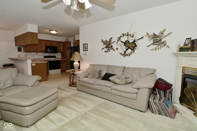 4528 Hunt Master Ct, Indianapolis, IN 46268 - living area with a ceiling fan, light carpet, and a glass covered fireplace