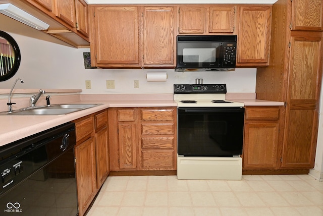4528 Hunt Master Ct, Indianapolis, IN 46268 - kitchen with black appliances, a sink, light countertops, and brown cabinetry