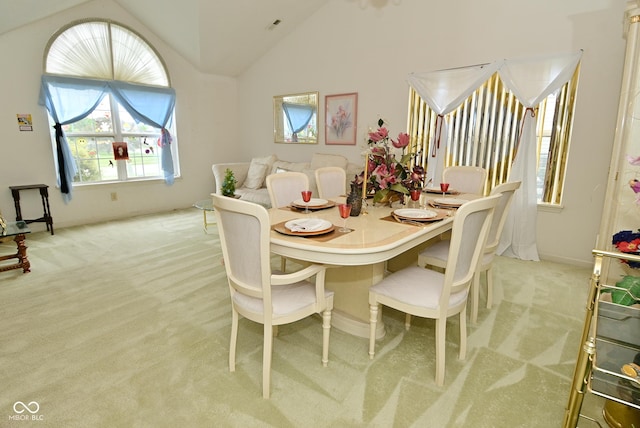 4528 Hunt Master Ct, Indianapolis, IN 46268 - dining area featuring light colored carpet, vaulted ceiling, and baseboards