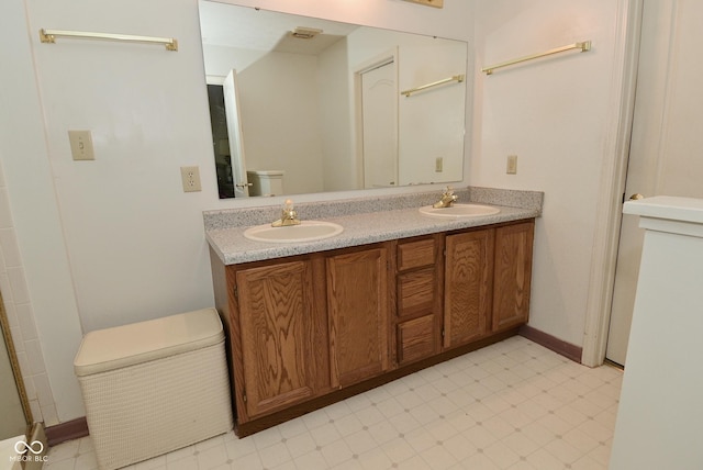 4528 Hunt Master Ct, Indianapolis, IN 46268 - full bath with double vanity, toilet, and baseboards