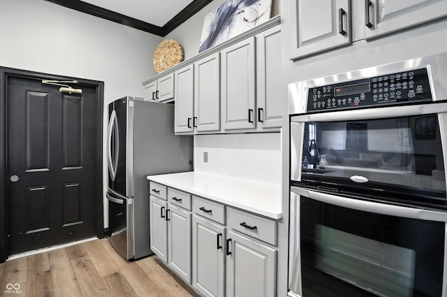 17233 Gunther Blvd Unit 102B, Westfield, IN 46074 - kitchen with stainless steel appliances, ornamental molding, light wood finished floors, and light countertops