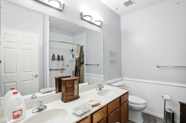 17233 Gunther Blvd Unit 102B, Westfield, IN 46074 - full bathroom featuring double vanity, wainscoting, wood finished floors, and curtained shower