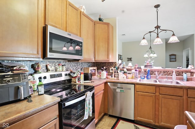 17233 Gunther Blvd Unit 102B, Westfield, IN 46074 - kitchen with appliances with stainless steel finishes, decorative backsplash, light countertops, and pendant lighting