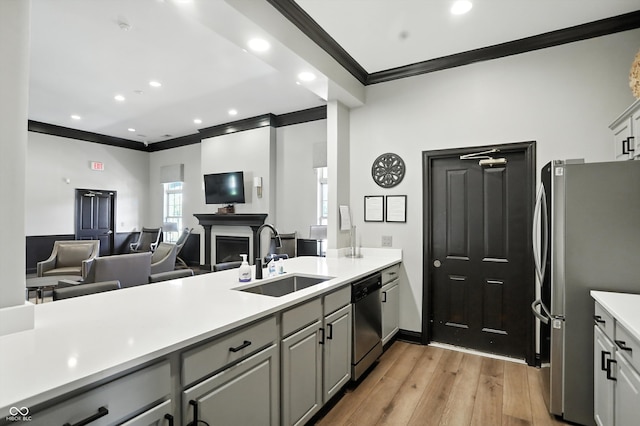 17233 Gunther Blvd Unit 102B, Westfield, IN 46074 - kitchen with appliances with stainless steel finishes, ornamental molding, gray cabinetry, light wood-style floors, and light countertops