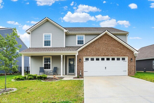 6645 Honeysuckle Way, Pendleton, IN 46064 - traditional-style house with covered porch, brick siding, driveway, an attached garage, and roof with shingles
