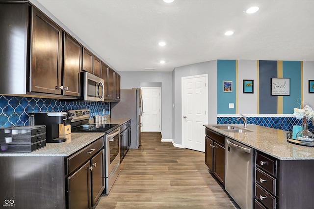 6645 Honeysuckle Way, Pendleton, IN 46064 - kitchen with stainless steel appliances, a sink, dark brown cabinetry, wood finished floors, and recessed lighting