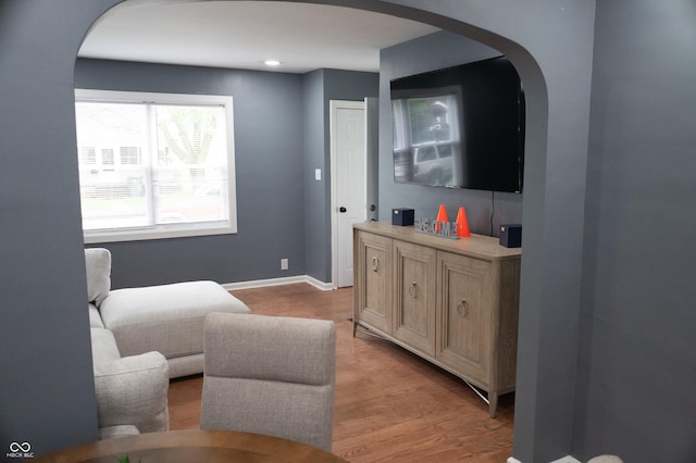 1331 N Berwick Ave, Indianapolis, IN 46222 - living room with arched walkways, light wood-style flooring, and baseboards