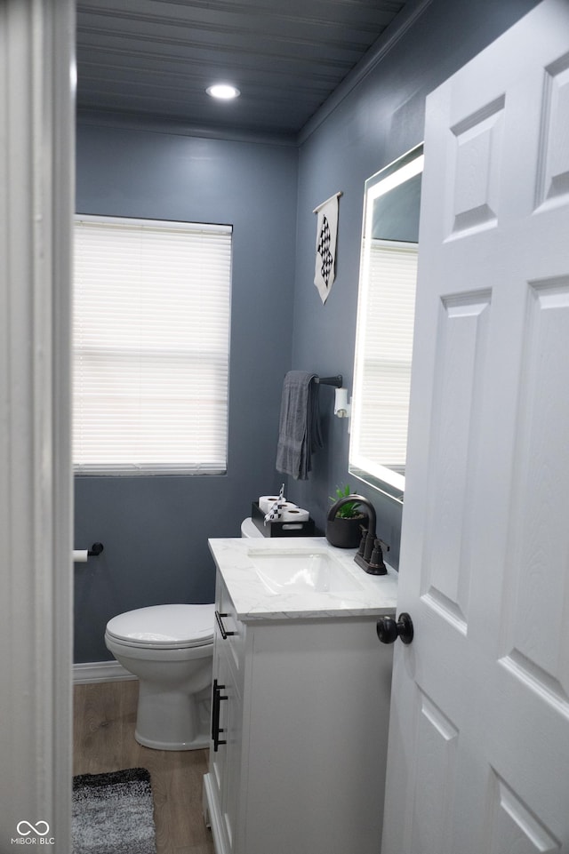 1331 N Berwick Ave, Indianapolis, IN 46222 - bathroom with healthy amount of natural light, vanity, toilet, wood finished floors, and wood ceiling