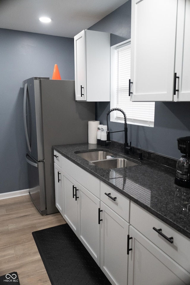 1331 N Berwick Ave, Indianapolis, IN 46222 - kitchen with a sink, white cabinets, light wood-style flooring, dark stone countertops, and recessed lighting