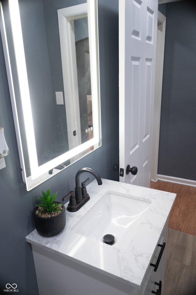 1331 N Berwick Ave, Indianapolis, IN 46222 - bathroom with vanity, wood finished floors, and baseboards
