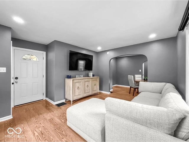 1331 N Berwick Ave, Indianapolis, IN 46222 - living room featuring arched walkways, light wood-type flooring, and recessed lighting