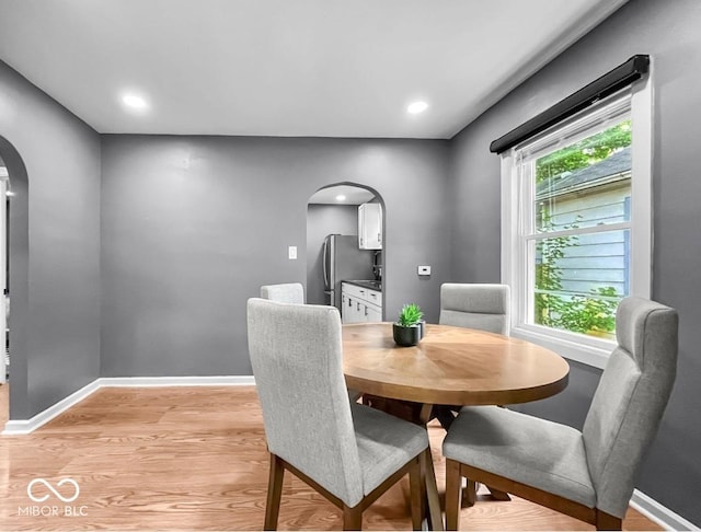 1331 N Berwick Ave, Indianapolis, IN 46222 - dining room featuring arched walkways, light wood-style floors, and recessed lighting