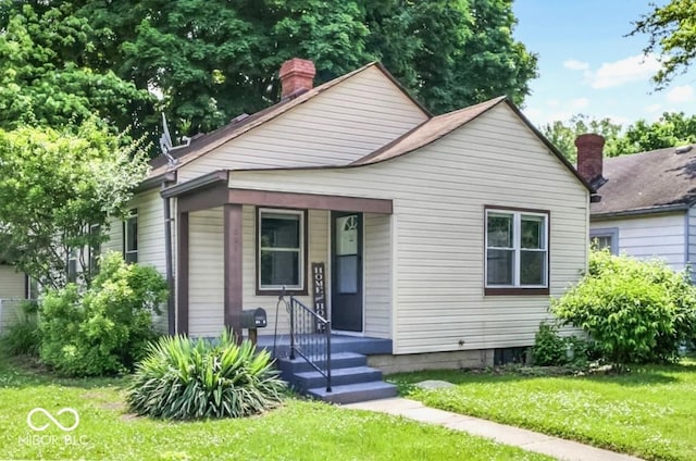 1331 N Berwick Ave, Indianapolis, IN 46222 - bungalow featuring a front lawn and a chimney