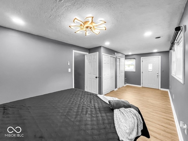 1331 N Berwick Ave, Indianapolis, IN 46222 - bedroom featuring wood finished floors, a textured ceiling, and recessed lighting
