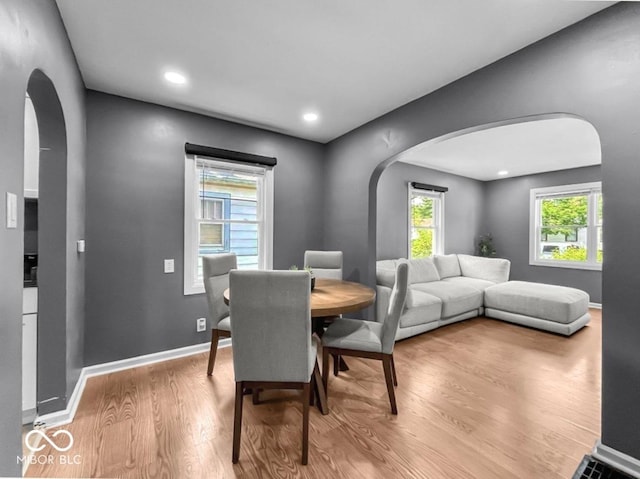 1331 N Berwick Ave, Indianapolis, IN 46222 - dining space featuring arched walkways, wood finished floors, and recessed lighting