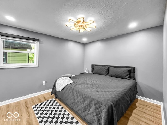 1331 N Berwick Ave, Indianapolis, IN 46222 - bedroom with light wood-type flooring, a textured ceiling, and recessed lighting