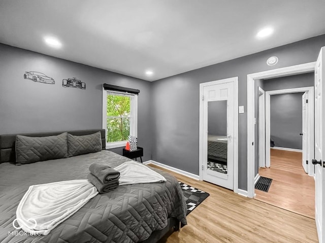 1331 N Berwick Ave, Indianapolis, IN 46222 - bedroom with light wood-style flooring and recessed lighting