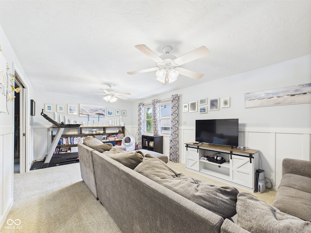 5542 N Olivia Dr, Alexandria, IN 46001 - carpeted living area with a wainscoted wall and ceiling fan