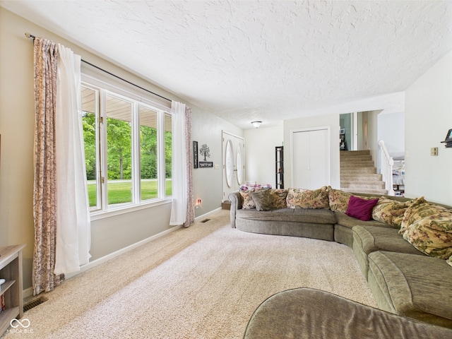 5542 N Olivia Dr, Alexandria, IN 46001 - carpeted living area featuring baseboards and a textured ceiling