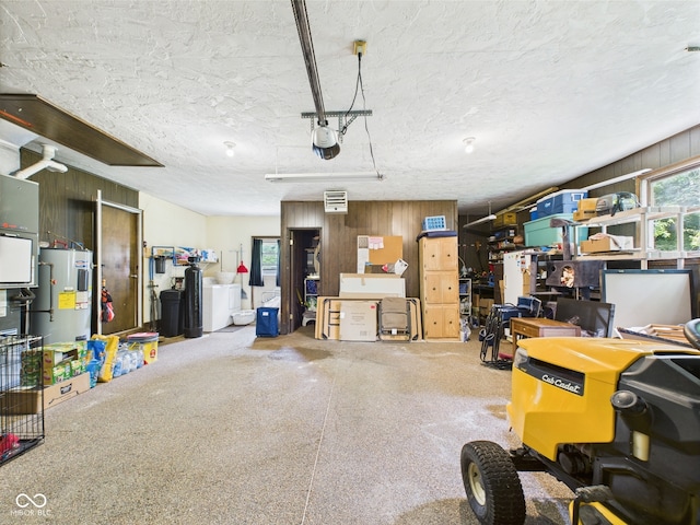 5542 N Olivia Dr, Alexandria, IN 46001 - garage featuring water heater, wooden walls, and a garage door opener