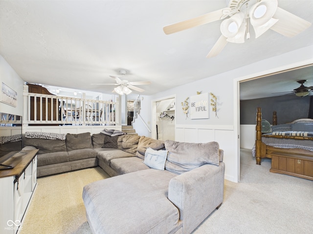 5542 N Olivia Dr, Alexandria, IN 46001 - living area with a ceiling fan, carpet, wainscoting, and stairway