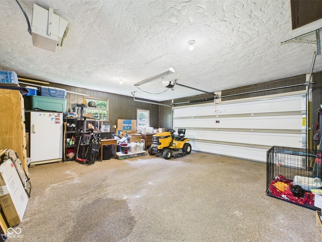 5542 N Olivia Dr, Alexandria, IN 46001 - garage with white refrigerator and a garage door opener