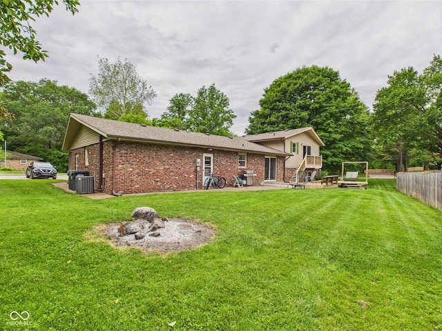 5542 N Olivia Dr, Alexandria, IN 46001 - back of house with brick siding, a deck, and central AC