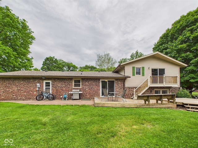 5542 N Olivia Dr, Alexandria, IN 46001 - rear view of property with a wooden deck, a yard, and brick siding