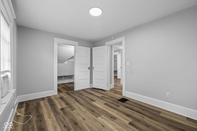 3227 Guilford Ave, Indianapolis, IN 46205 - unfurnished bedroom with baseboards, wood finished floors, a spacious closet, and a closet