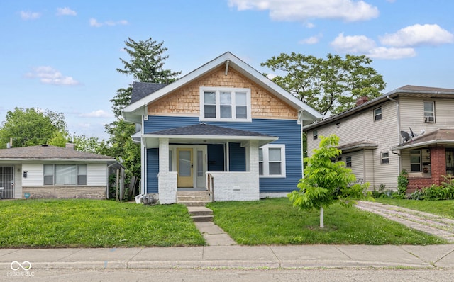 3227 Guilford Ave, Indianapolis, IN 46205 - view of front of house featuring a front yard and a shingled roof