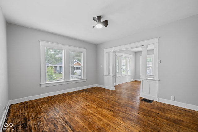 3227 Guilford Ave, Indianapolis, IN 46205 - spare room featuring healthy amount of natural light, hardwood / wood-style flooring, baseboards, and ornate columns