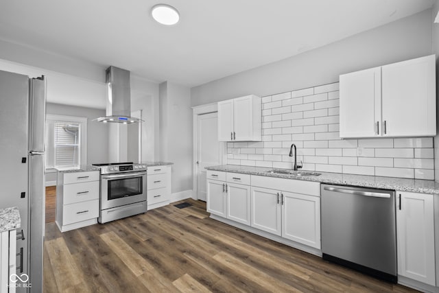 3227 Guilford Ave, Indianapolis, IN 46205 - kitchen featuring appliances with stainless steel finishes, a sink, exhaust hood, backsplash, and white cabinetry