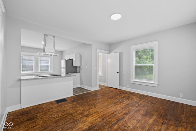3227 Guilford Ave, Indianapolis, IN 46205 - unfurnished living room featuring baseboards and dark wood-type flooring