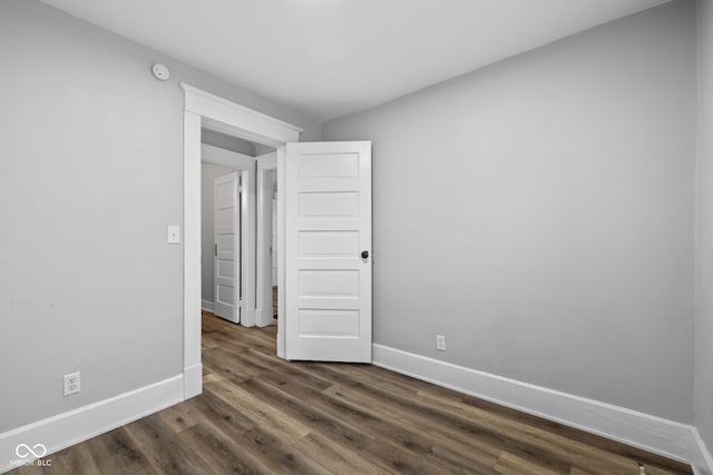 3227 Guilford Ave, Indianapolis, IN 46205 - spare room featuring baseboards, dark wood-type flooring, and a smoke detector